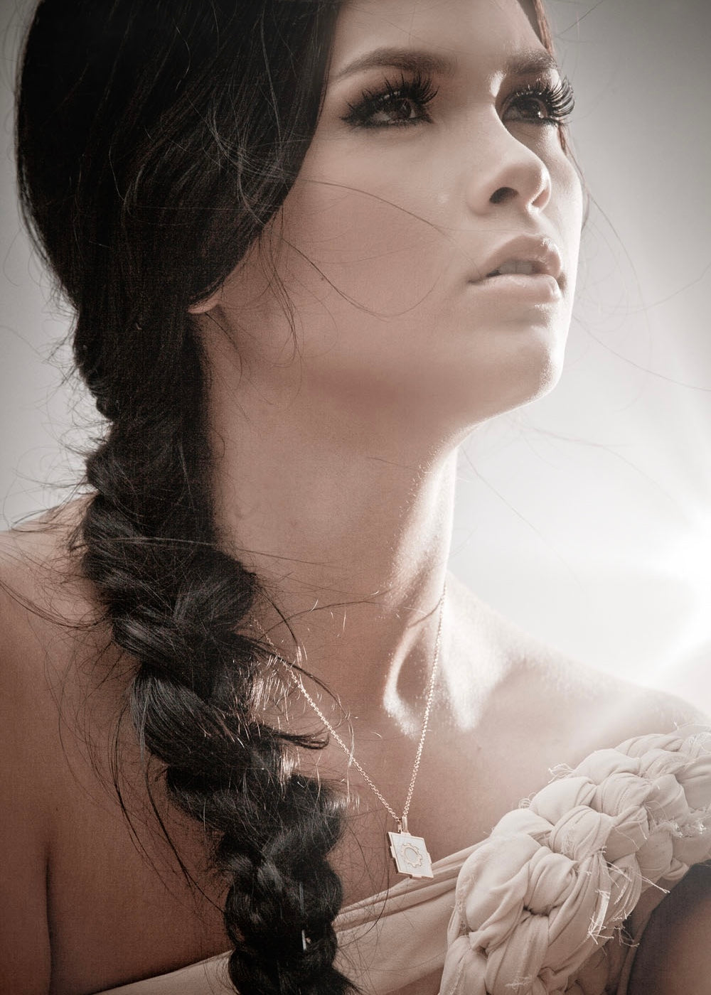 Model with brown braided hair wearing a tigers and dragons gold mandala necklace
