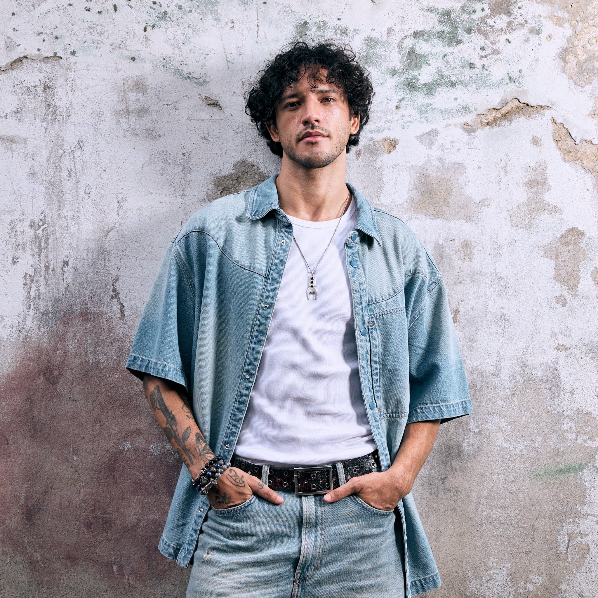 Male model wearing a silver and onyx rocket necklace