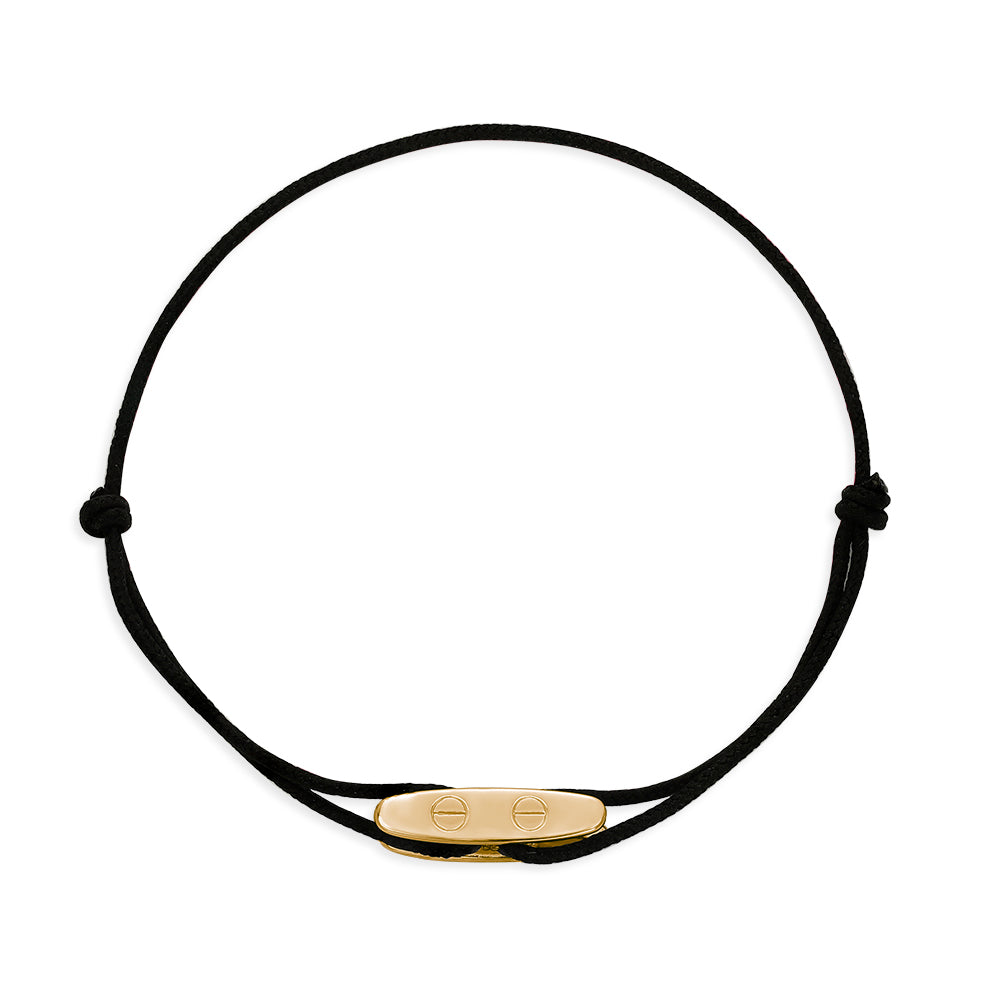 Black cord bracelet with a gold nautical element charm