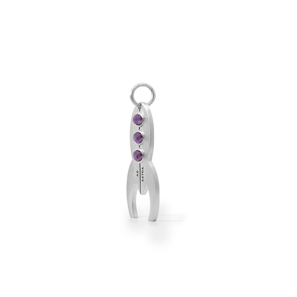 Side view of a silver rocket pendant with purple stones as windows