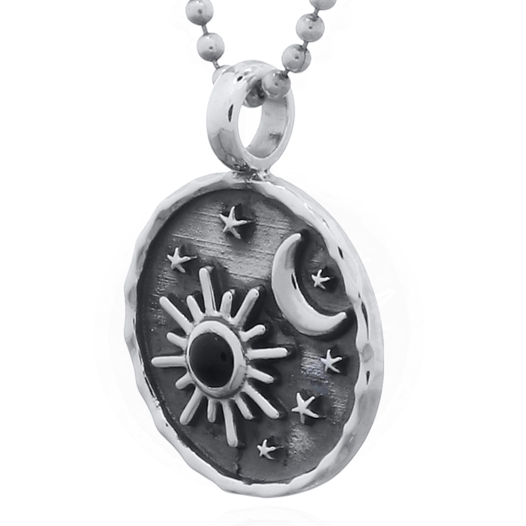 Silver pendant with sun, moon, and star design side view