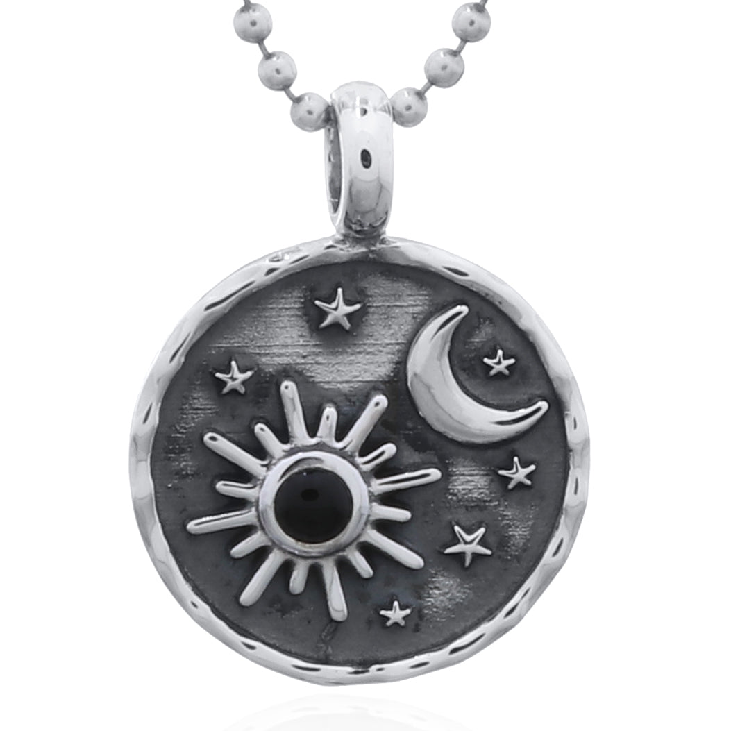 Silver pendant with sun, moon, and stars design