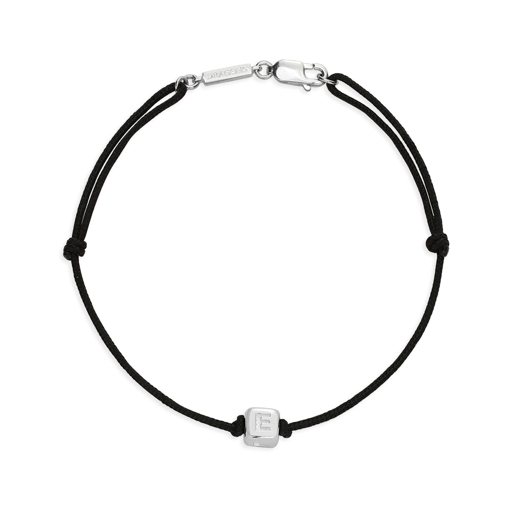 Black cord bracelet with silver clasp and square charm showing the letter E of Love.