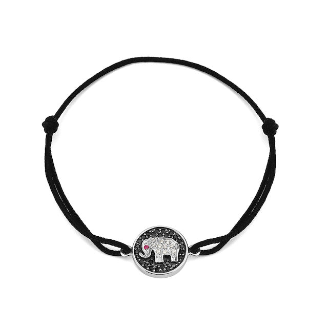 A black bracelet with a silver elephant charm with nano stones in the center