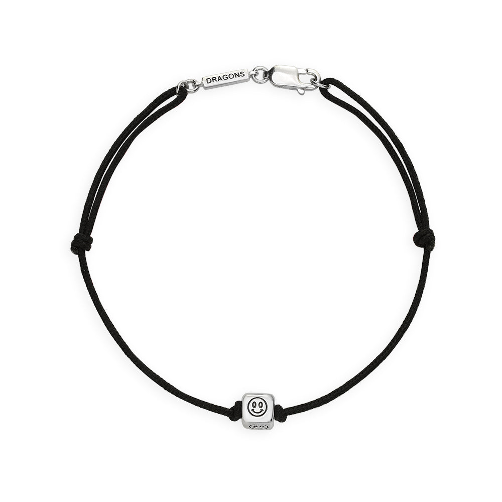 Black cord bracelet with a silver smiley face charm