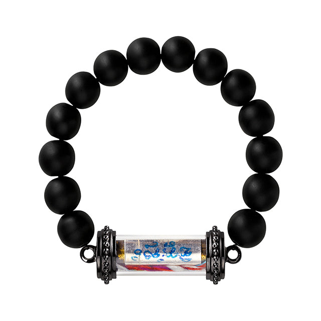 A black bead bracelet with a Thai amulet with sacred sanskrit text written on a silver scroll