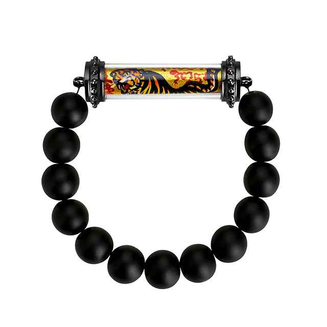Onyx beaded bracelet featuring a Thai amulet with a tiger and sanskrit text